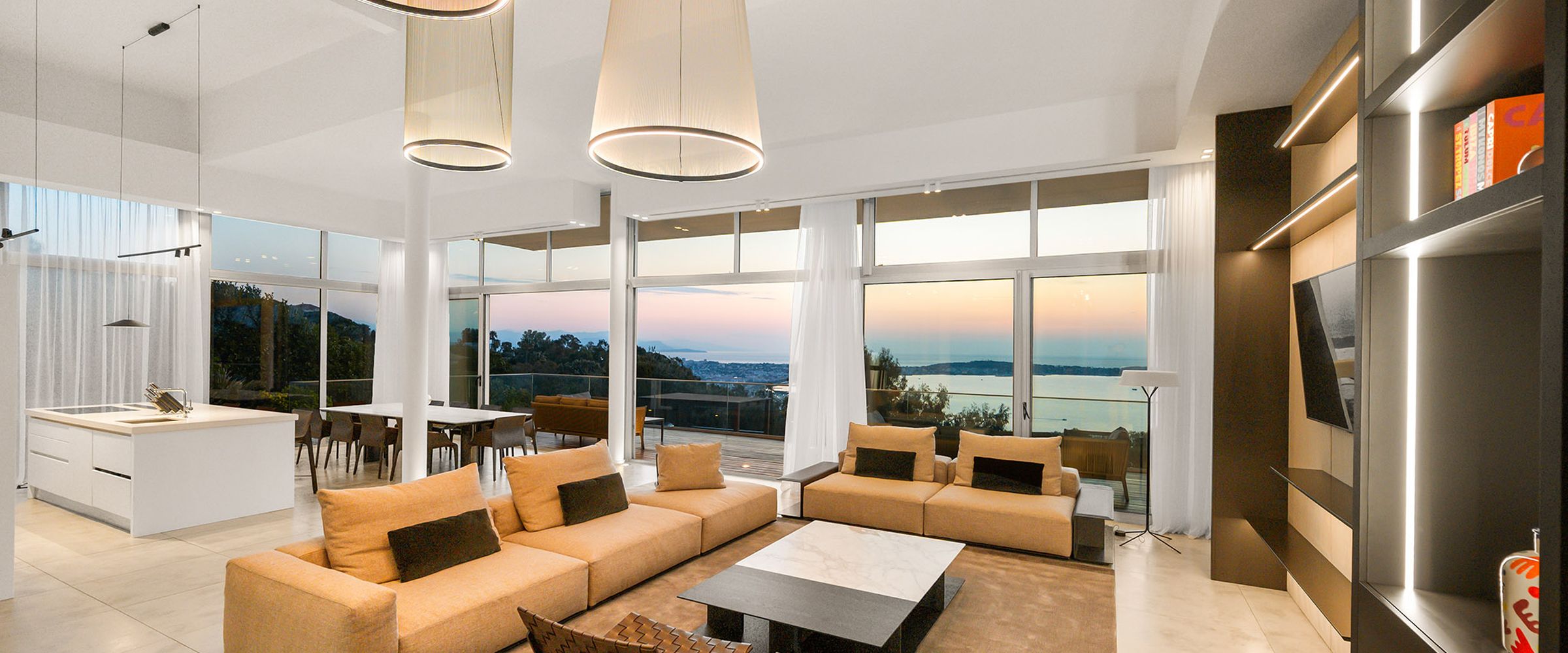 Living room with the sun setting through the glass